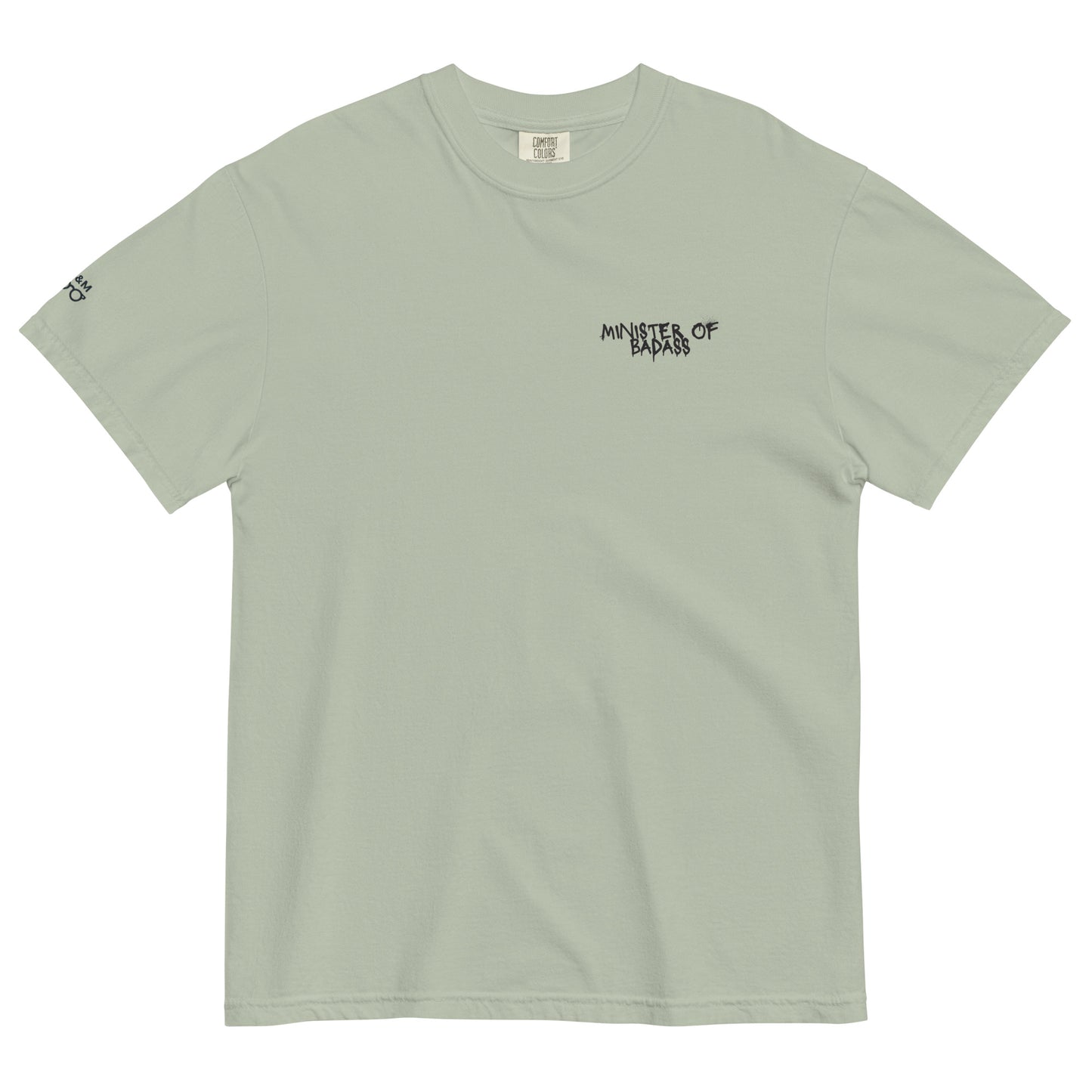 Muted green t-shirt showcasing the 'Minster of Badass' text alongside a bold teddy bear graphic, combining cool tones with an edgy design