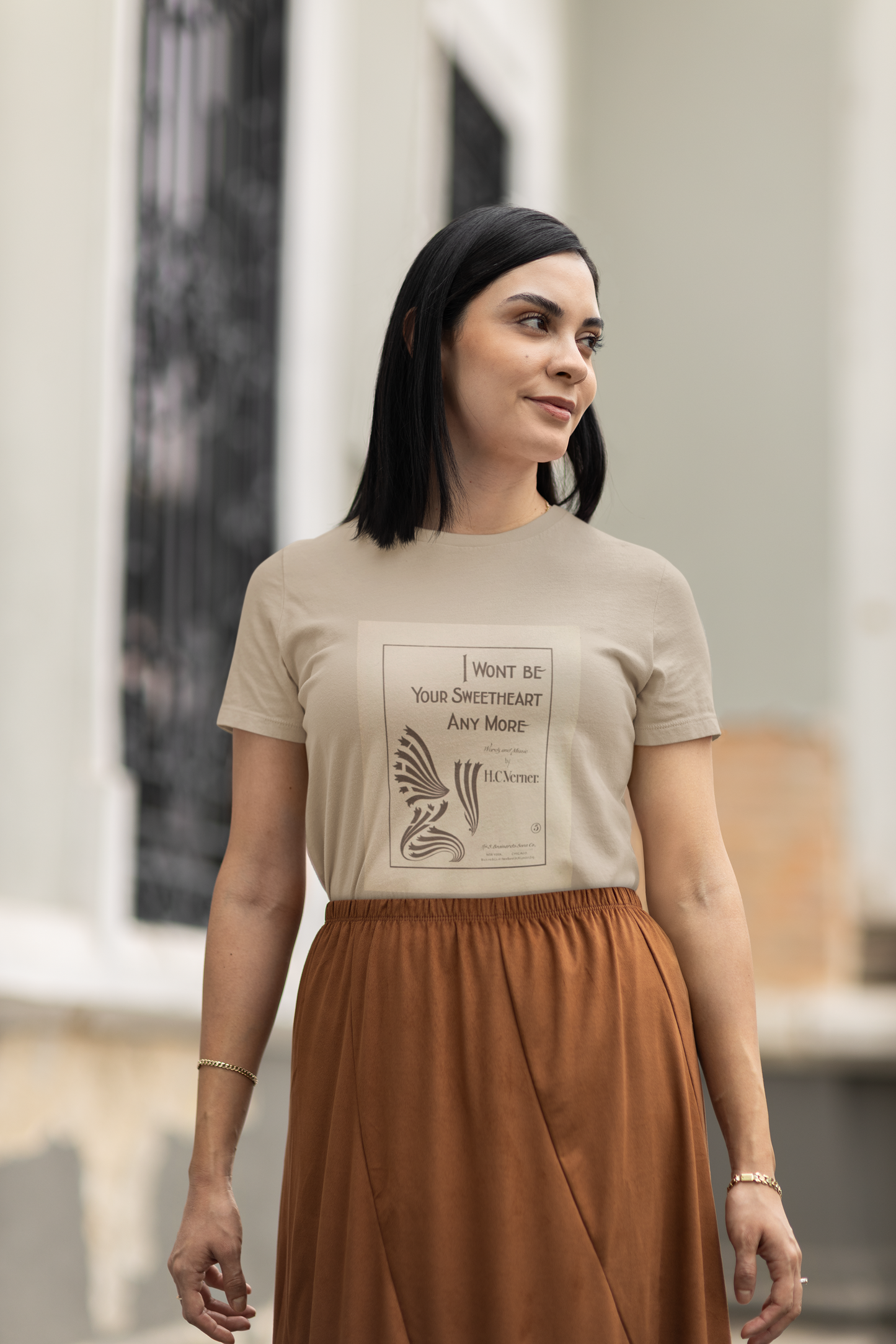 A woman wearing natural color t-shirt featuring an authentic vintage print of a music cover