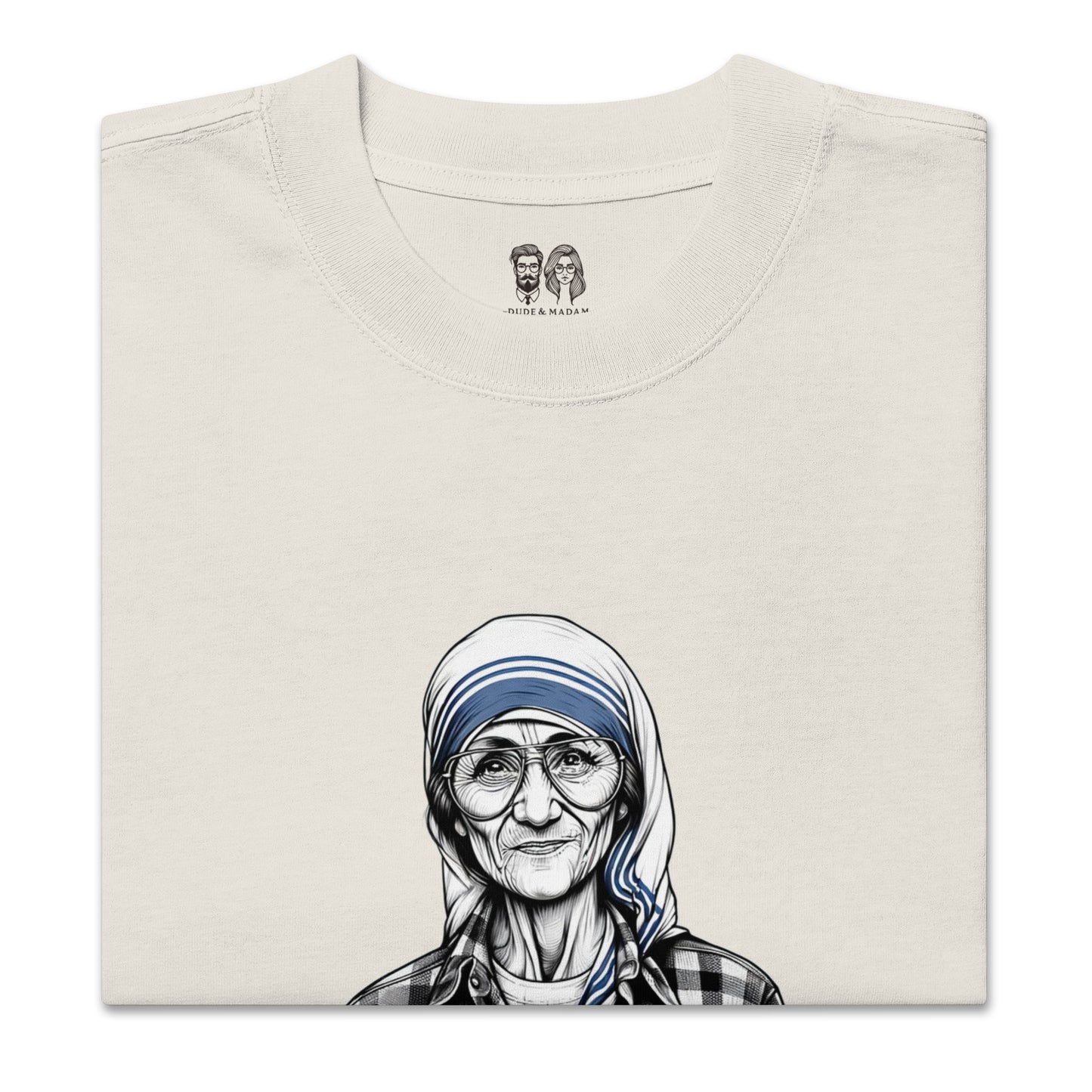 Folded bone cotton shirt with Mother Teresa saying peace starts with a smile quote and the dude and madam logo