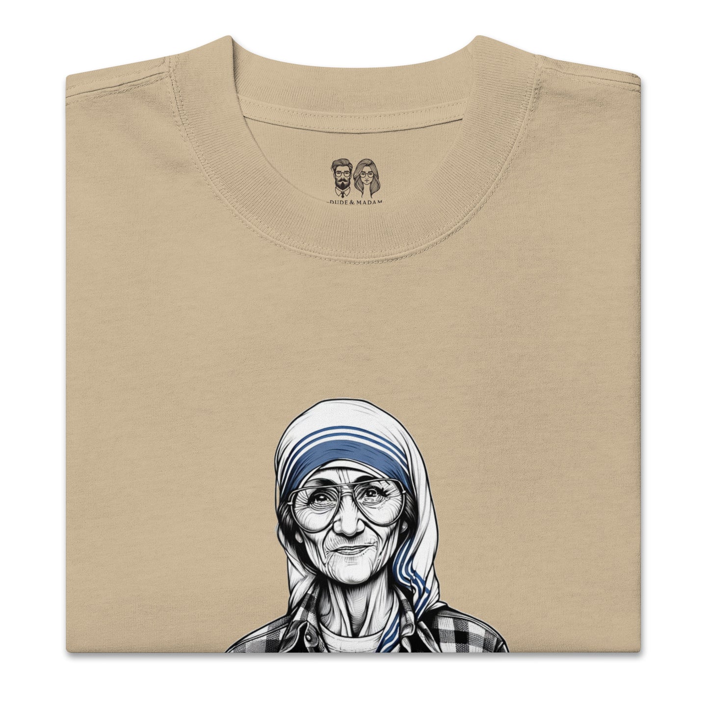 Folded Beige cotton shirt with a print of Mother Teresa saying peace starts with a smile quote and the dude and madam logo