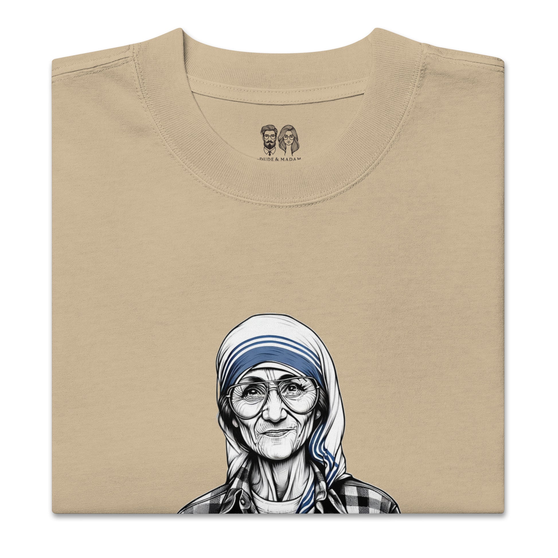 Folded Beige cotton shirt with a print of Mother Teresa saying peace starts with a smile quote and the dude and madam logo