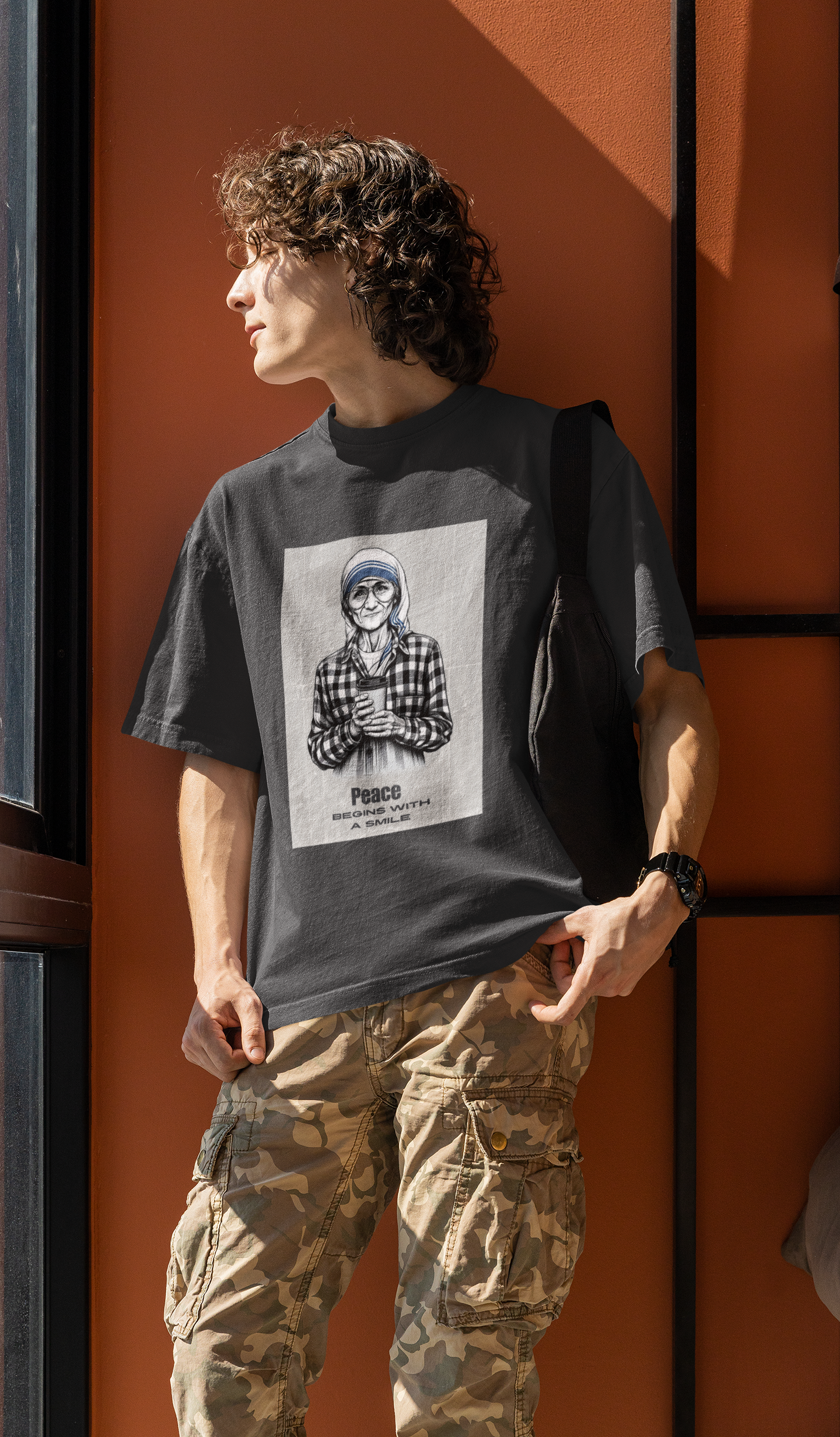 A men wearing streetwear style oversized mother teresa t shirt