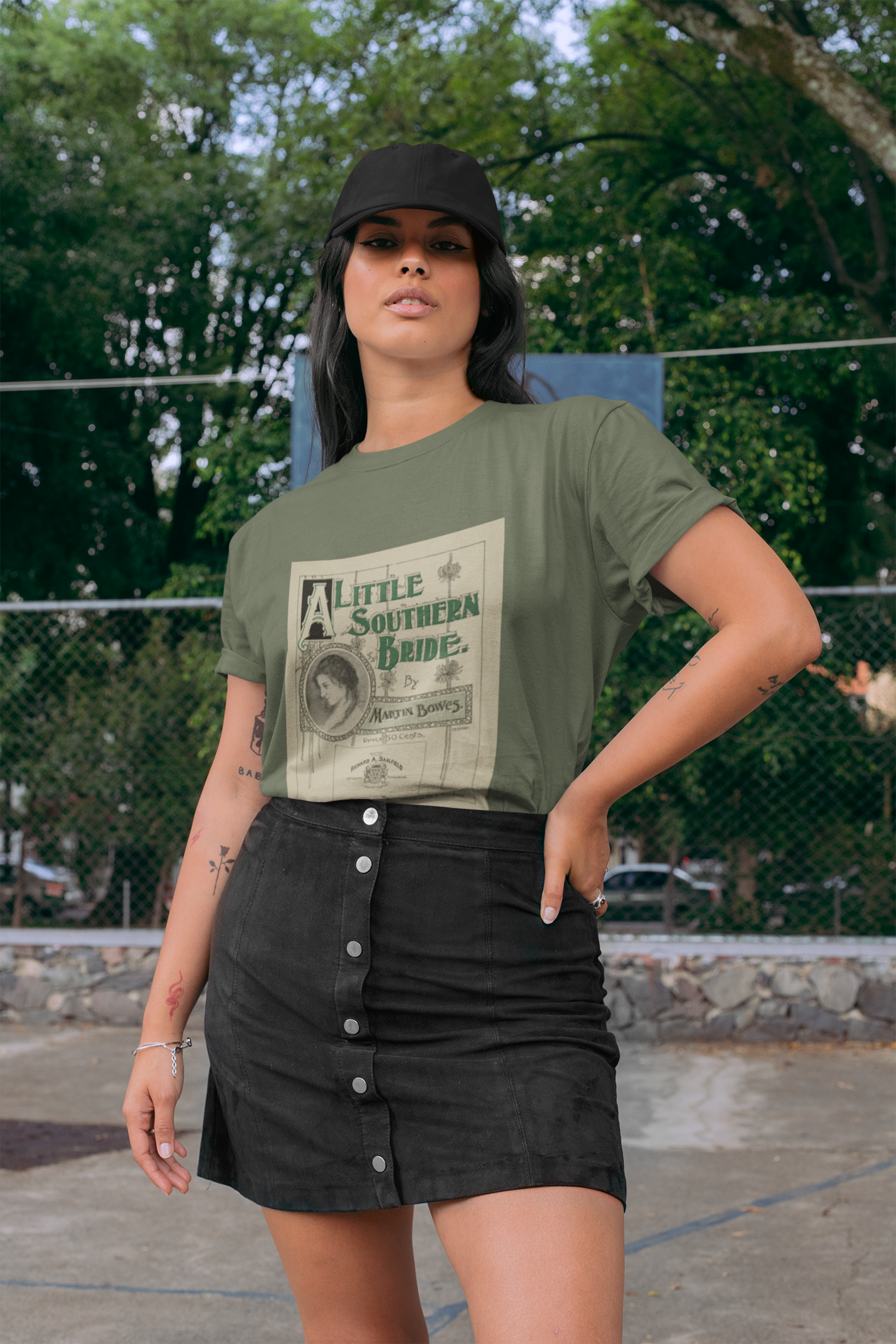 Woman in a mini skirt wearing a green t shirt with a large print of a retro music cover called a little southern bride