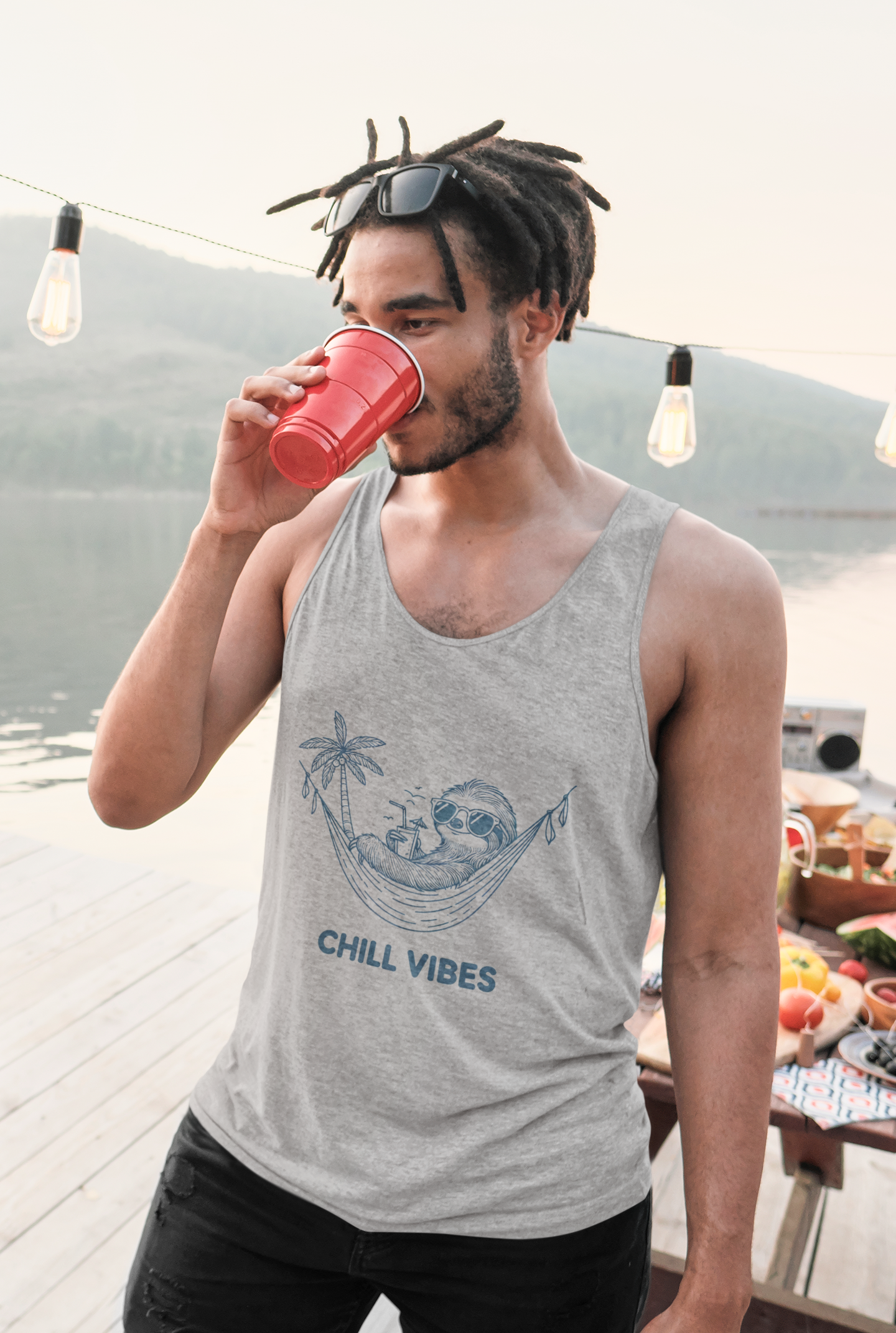 Cool man rasta Cotton tank top featuring a sloth lounging in a hammock with sunglasses and a drink, captioned 'Chill Vibes', perfect for a fun and relaxed look